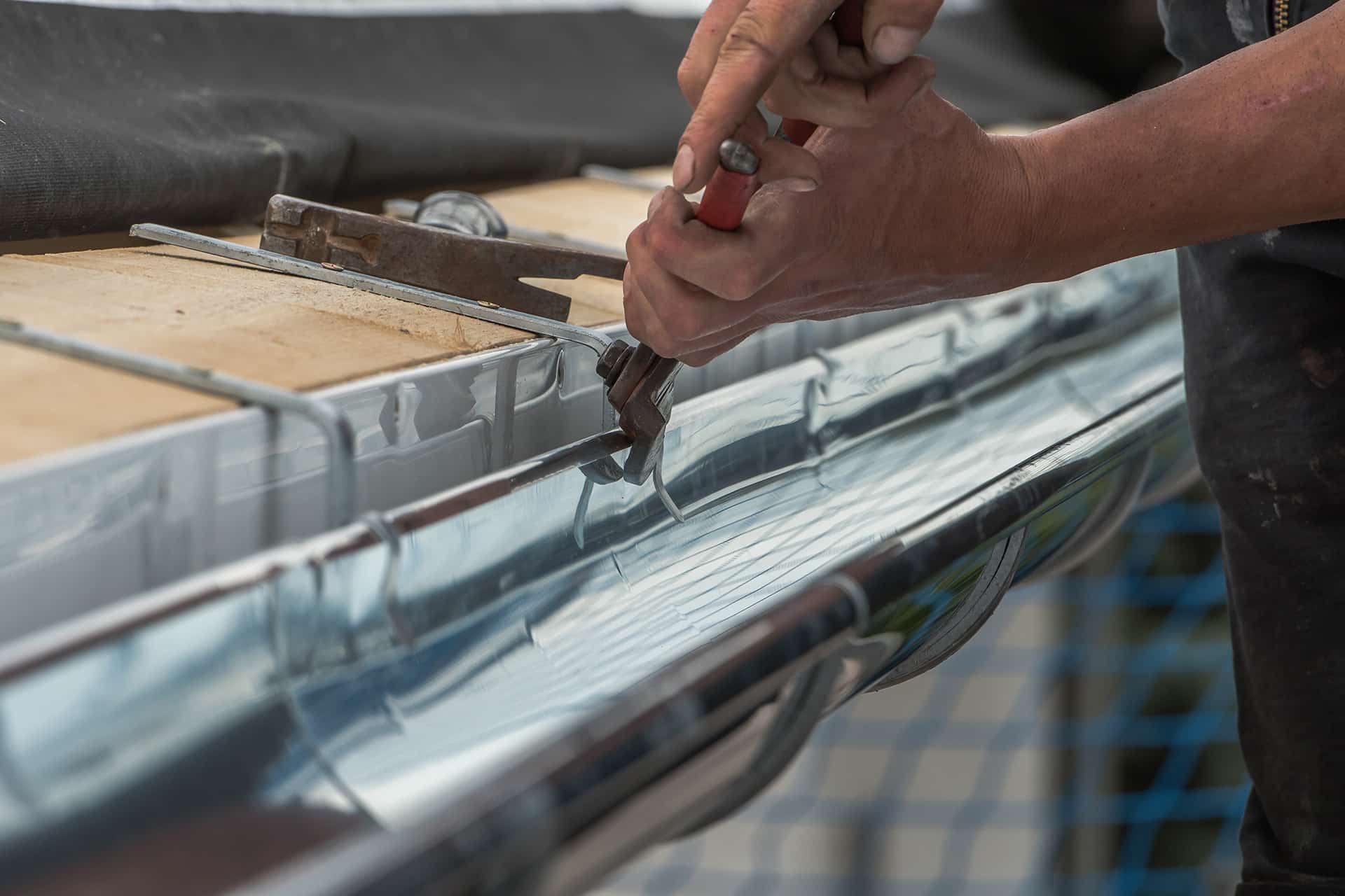 Close up of a newly installed gutter on a roof. Craftsmanship in